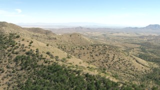 AF0001_000871 - HD aerial stock footage of flying over Mae West Peaks to approach Dragoon, Cochise County, Arizona