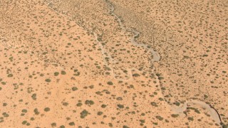 AF0001_000889 - HD aerial stock footage of a bird's eye view of a dry creek bed through desert, New Mexico