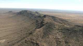 AF0001_000892 - HD stock footage aerial video of flying by a desert mountain ridge, New Mexico