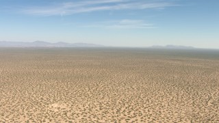 AF0001_000895 - HD aerial stock footage of flying over a dry desert plain in New Mexico