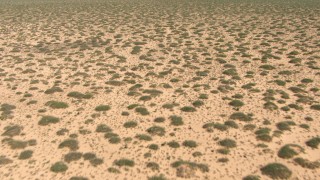 AF0001_000898 - HD stock footage aerial video fly low over a flat desert plain in New Mexico