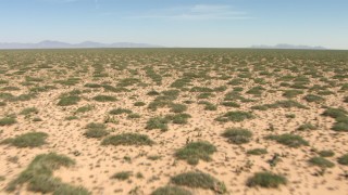 AF0001_000899 - HD stock footage aerial video fly low over plants in a desert plain in New Mexico