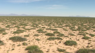 AF0001_000901 - HD stock footage aerial video of desert plants in a wide, arid plain in New Mexico
