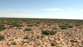 AF0001_000910 - HD stock footage aerial video fly low past a desert plain, New Mexico