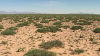 AF0001_000911 - HD stock footage aerial video of low altitude flight over plants in a desert plain in New Mexico