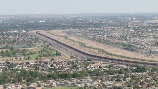 AF0001_000941 - HD aerial stock footage of Highway 375 and the fence on US/Mexico border, El Paso, Texas