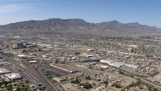 AF0001_000945 - HD stock footage aerial video of Fox Plaza shopping center, warehouse buildings, and neighborhoods near the Franklin Mountains in El Paso, Texas