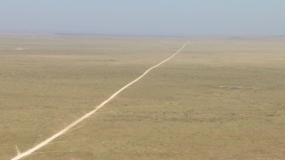 AF0001_000961 - HD stock footage aerial video of a dirt road through a wide desert plain near El Paso, Texas