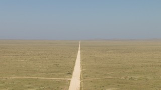 AF0001_000963 - HD stock footage aerial video of following a dirt road through a desert plain near El Paso, Texas