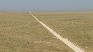 AF0001_000964 - HD stock footage aerial video of passing a dirt road cutting through a desert plain, El Paso, Texas
