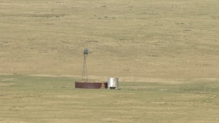 AF0001_000967 - HD stock footage aerial video of a windmill and a water tank on a ranch near El Paso, Texas