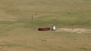 AF0001_000968 - HD stock footage aerial video flyby a windmill and water tank on a ranch near El Paso, Texas