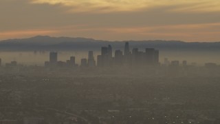 AF0001_000985 - 5K aerial stock footage of a view of the Downtown Los Angeles skyline in haze at sunset, California