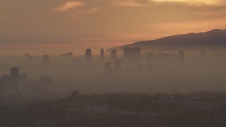 AF0001_000993 - 5K aerial stock footage of Century City skyscrapers in haze at sunset, California