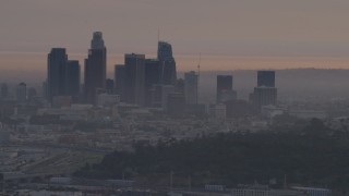 AF0001_000996 - 5K aerial stock footage of the Downtown Los Angeles skyline seen from Dodger Stadium at twilight, California
