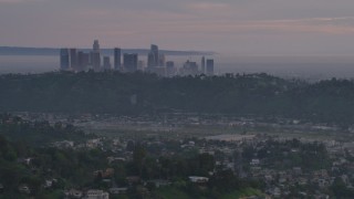 AF0001_001001 - 5K aerial stock footage of Downtown Los Angeles skyline seen from hillside homes at twilight, California