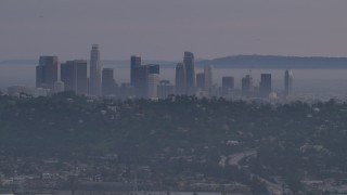 AF0001_001003 - 5K aerial stock footage of Downtown Los Angeles skyline behind hilltop Silver Lake homes at twilight, California