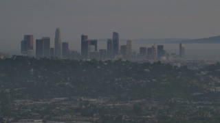 AF0001_001004 - 5K aerial stock footage of a view of Downtown Los Angeles skyline and hillside homes in Silver Lake at twilight, California