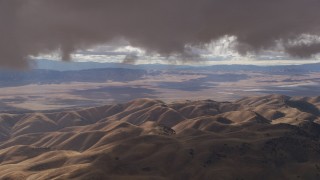 AF0001_001011 - 8K aerial stock footage of low clouds over desert hills in Southern California