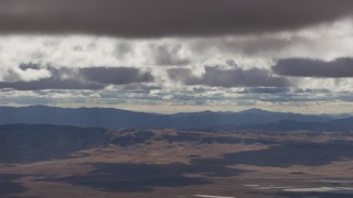 AF0001_001012 - 8K aerial stock footage of clouds over desert hills and mountains in Southern California