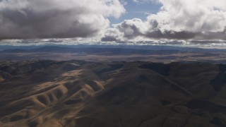 AF0001_001014 - 8K aerial stock footage of godrays and clouds over desert hills in Southern California
