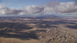 AF0001_001019 - 8K aerial stock footage of clouds over desert hills in Southern California
