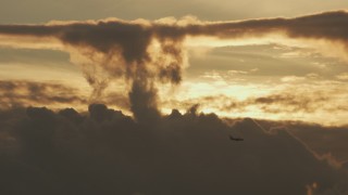 AF0001_001036 - 8K aerial stock footage track a passenger jet flying over the clouds at sunset in Northern California