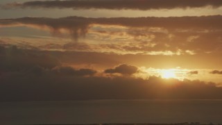 AF0001_001039 - 8K aerial stock footage setting sun dipping behind clouds formations in Northern California
