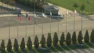 AI05_DAL_08 - 1080 aerial stock footage orbiting flags in front of AT&T Stadium, Arlington, Texas