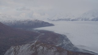 AK0001_0025 - 4K aerial stock footage pan right by Knick Glacier, bordered by Chugach Mountains, Knik Glacier, Alaska