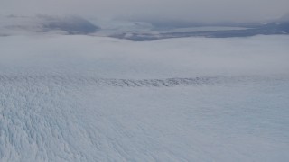 AK0001_0026 - 4K aerial stock footage tilting up to reveal Knik Glacier, distant mountains, Knik Glacier, Alaska