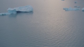AK0001_0042 - 4K aerial stock footage flying low over the lake surface, approaching icebergs, Inner Lake George, Alaska