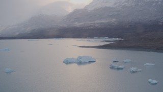 AK0001_0043 - 4K aerial stock footage flying over icebergs, approach snow covered mountains, Inner Lake George, Alaska