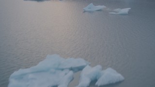 AK0001_0045 - 4K aerial stock footage fly over icebergs, reveal lake, snow covered mountains, Inner Lake George, Alaska