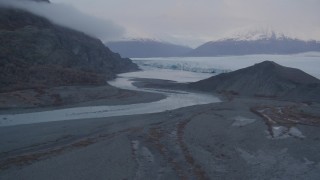 AK0001_0048 - 4K aerial stock footage of flying low over a river and approaching a glacier-covered lake, twilight, Knik, Alaska