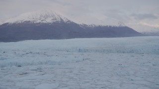 AK0001_0056 - 4K aerial stock footage flying low over an ice covered lake, near glacier, Knik, Alaska