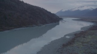 AK0001_0058 - 4K aerial stock footage following a river, approaching a valley, Chugach Mountains, Knik, Alaska