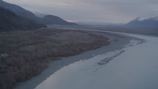 AK0001_0059 - 4K aerial stock footage following a river, approaching a valley, Chugach Mountains, Knik, Alaska