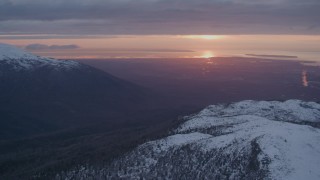 AK0001_0093 - 4K aerial stock footage pan left by Anchorage, seen from Chugach Mountains, Alaska, sunset