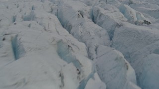 AK0001_0141 - 4K aerial stock footage flying low over surface of Knik Glacier, tilt up, Knik Glacier, Alaska