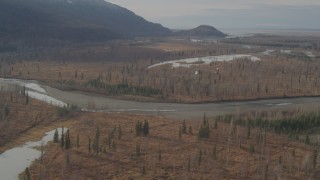 AK0001_0149 - 4K aerial stock footage following a helicopter, over rivers, countryside, Knik River Valley, Alaska