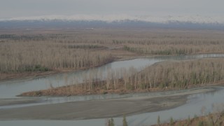 AK0001_0152 - 4K aerial stock footage flying along the river, Chugach Mountains in the distance, Knik River Valley, Alaska