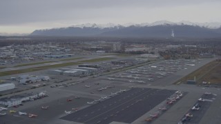 AK0001_0157 - 4K aerial stock footage flying low over Merrill Field runways, parked planes, Anchorage, Alaska