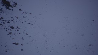 AK0001_0191 - 4K aerial stock footage fly over snowy slope to reveal Downtown Anchorage and Merrill Field, Alaska, night