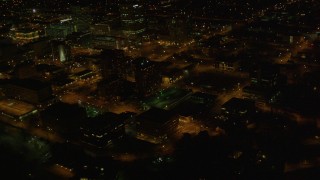 AK0001_0208 - 4K aerial stock footage flying by Hotel Captain Cook, tilt up to reveal Downtown Anchorage, Alaska, night