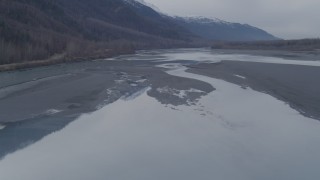 AK0001_0217 - 4K aerial stock footage flying along the river, approaching Chugach Mountains, Knik River, Alaska