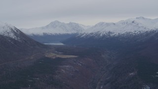 AK0001_0227 - 4K aerial stock footage flying by Eklutna Lake, bordered by the Chugach Mountains, Alaska