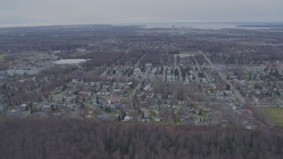 AK0001_0242 - 4K aerial stock footage flying over mobile home park, approaching Downtown Anchorage, Alaska