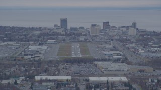 AK0001_0243 - 4K aerial stock footage approaching Merrill Field, Downtown buildings, Anchorage, Alaska