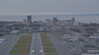 AK0001_0245 - 4K aerial stock footage approaching Merrill Field, quick zoom to Downtown buildings, Anchorage, Alaska